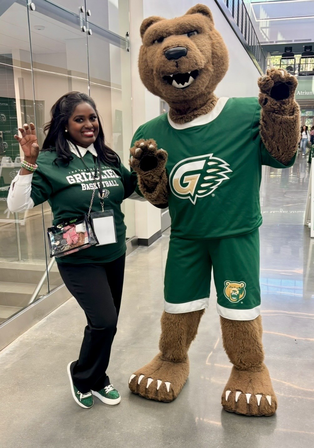 Woman in GGC shirt with Bear in basketball uniform